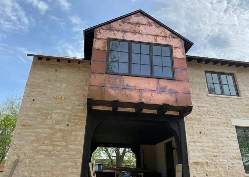 Copper metal panel facade on a stone building for Roof Repair in East Highland Park