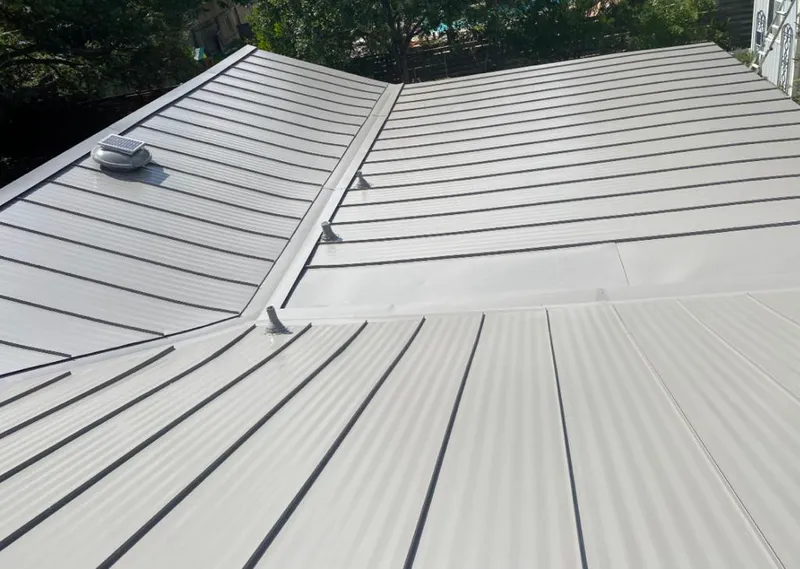Solar attic fan installed on a metal roof for Roof Ventilation in East Highland Park